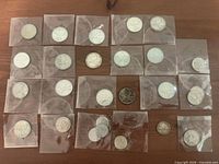 Overhead view of all bagged coins laid out on surface