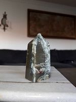 Front angle showing full obelisk, plume patterns and accent stone
