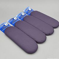 Four plum Goldline Airway X broom pads in a row