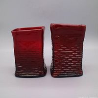 Front view two red glass vases showing size, color, texture