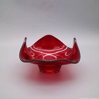 Front view showing ruby red bowl with flared rim and pedestal base
