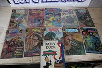 Group shot of all 10 bagged comic books with Daffy Duck issue on top