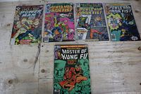 Group shot of all five bagged comics on table