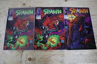 Front covers of three Spawn comics: two issue #1 and one issue #2