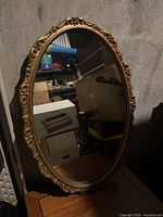 Front view of ornate oval mirror