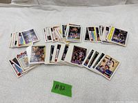 Spread of all Topps basketball cards laid out on white surface, green tape marked #82 visible