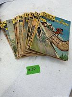 Stack of 10 Classics Illustrated comics, top book The Pathfinder No.22 visible