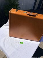 Exterior of tan leather Samsonite attaché closed, showing overall condition