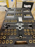 open tap and die set showing taps, dies, wrenches and case layout