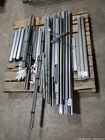 pallet with assorted galvanized steel framing rails, threaded rods, brackets, plates