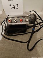 Rear view of adapter showing RCA audio ports and labeling
