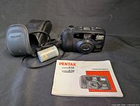 Camera with case, film canister, and manual