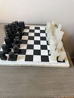 Full view of stone chess board with pieces set up