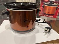 Front view of cooker with attached cord and box