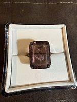 Top view showing large rectangular purple glass stone in prong setting