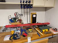 Workbench overview showing majority of tools and five bar clamps mounted above
