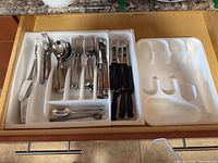 Drawer view showing full set of flatware and tray