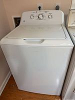 Front view of GE top load washing machine closed