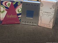 Front view of the three sealed perfume boxes