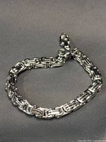 Bracelet laid in semi-circle showing link design and clasp