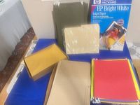 Overall lot showing HP paper box, colored paper stacks, manila folders, envelopes, hanging folder tabs