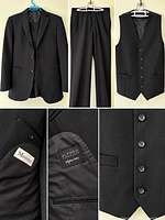 Full view of jacket, trousers, vest on hangers