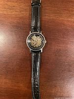 Front view of watch on strap