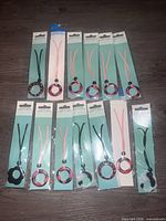 Front view of all 14 packaged eyeglass cords displaying cord colors and pendant styles