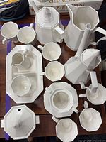 Overhead view of entire Nikko porcelain set showing coffee pot, pitcher, sugar bowl, creamers, tray, cups and saucers