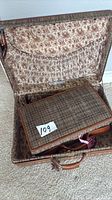 Suitcase open showing interior and one removable tweed pouch
