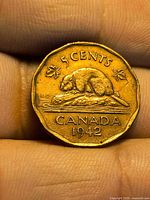 Reverse of 1942 Canadian 5-cent coin showing beaver design, date and denomination