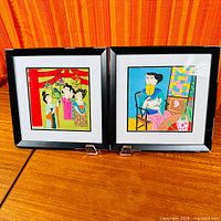 Both framed paintings side-by-side