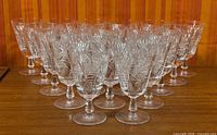 Front angled view showing all 20 cut crystal wine glasses on table