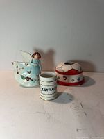 All three items grouped together: angel figurine, Estragon jar, soccer coin bank