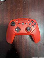 Front view of red Surge wireless controller showing buttons and sticks