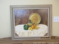 frontal view of framed oil painting showing still life subject