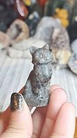 Front view of gray speckled Yooperlite cat figurine held in hand