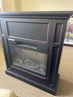 Front view of black mantel and firebox
