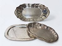 Group shot of three silverplate trays showing shapes and sizes