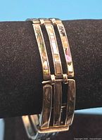 Front view of bracelet showing abalone inlay and link design