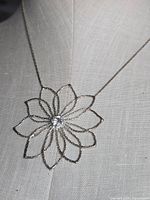 Front view of necklace showing entire flower pendant and chain