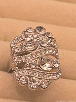 Front view of silver-tone ring with rhinestone detailing