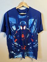 Front view of blue Spider-Man graphic t-shirt on hanger