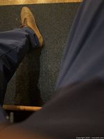 Person standing on dark blue yoga mat corner visible