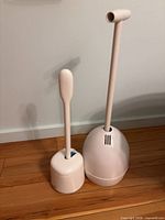 Two plungers in their holders standing upright