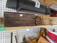 First photo showing three wood boxes including one with round wood slice top lid and one with a lid that does not close closely.