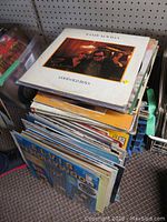 Stack of vinyl LP records showing Randy Newman "Good Old Boys" on top and an assortment of other albums beneath it including Elvis Presley "In Hollywood".