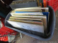 Box containing approximately 78 78 rpm vinyl records with various album covers visible from above