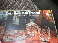 Photo showing product box with text 'Early American Prescut 7 Piece Table Service Set' and showing some glass pieces including butter dish and creamer.