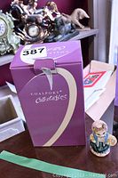 Original purple box of Coalport Collectables for Birthday Collection February Amethyst figure, with the small figurine beside it.